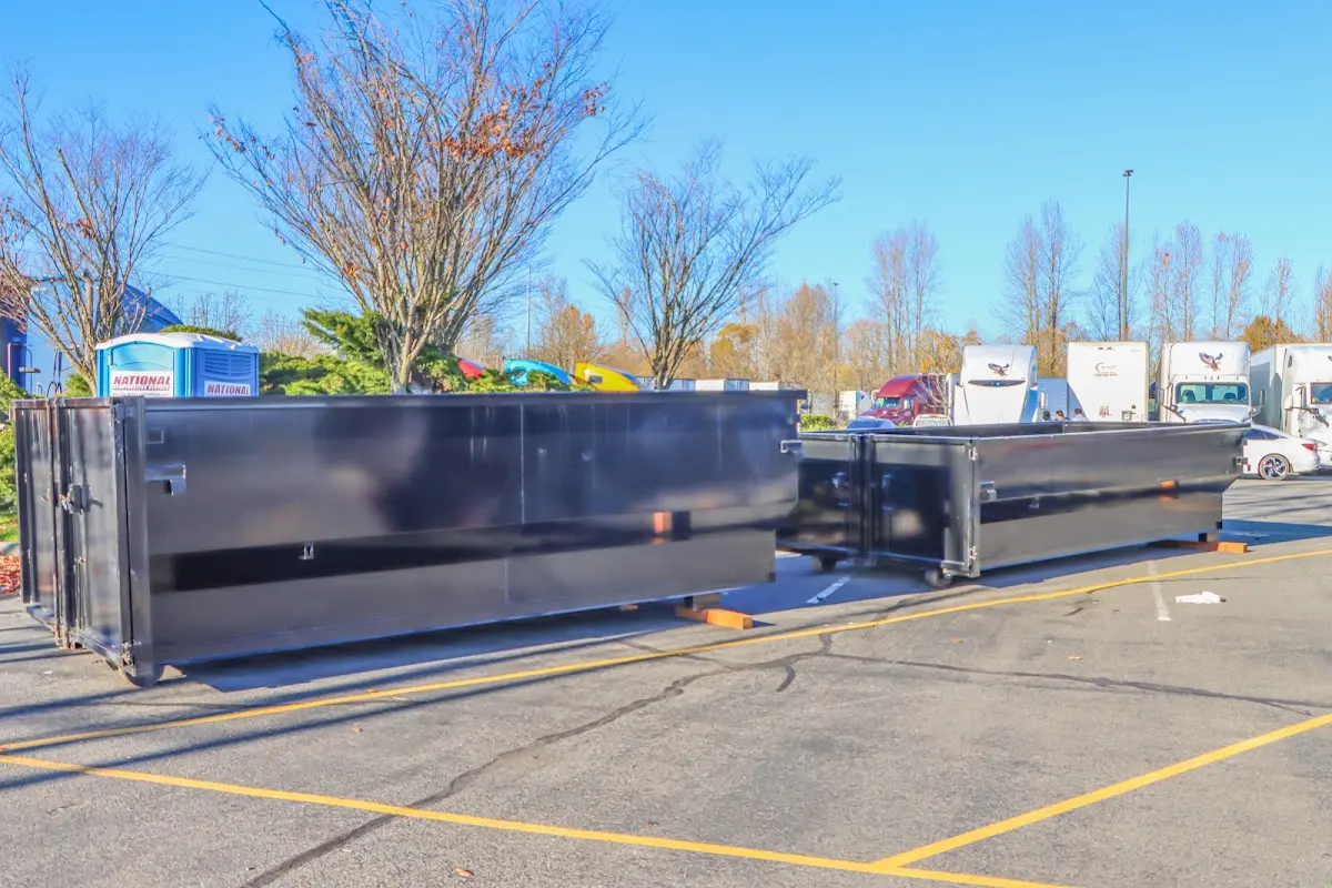 Professional dumpster rental service with roll-off container on residential driveway in New Whiteland